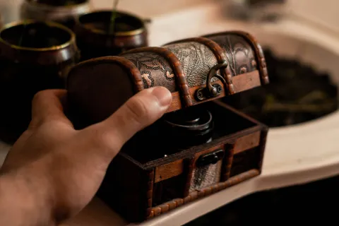 Hand holding small treasure chest.
