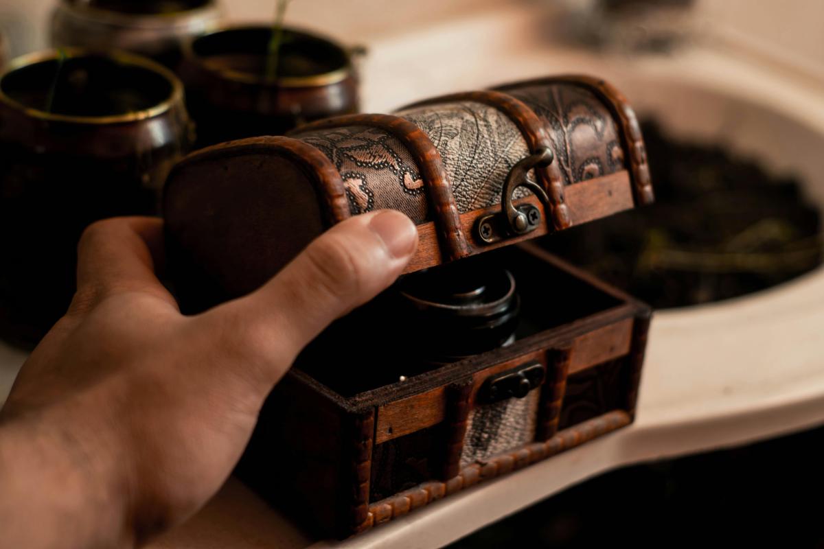 Hand holding small treasure chest.